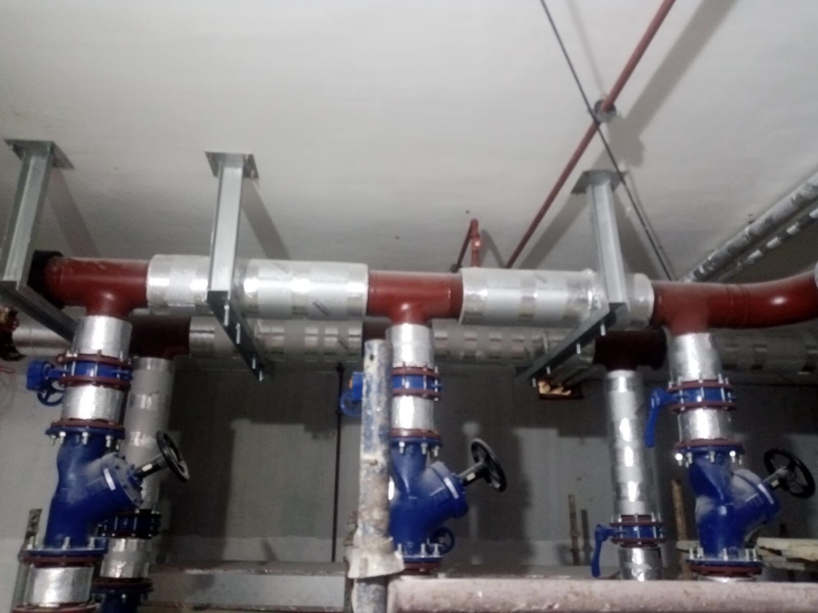 Chilled water header with blue butterfly valves in pump room