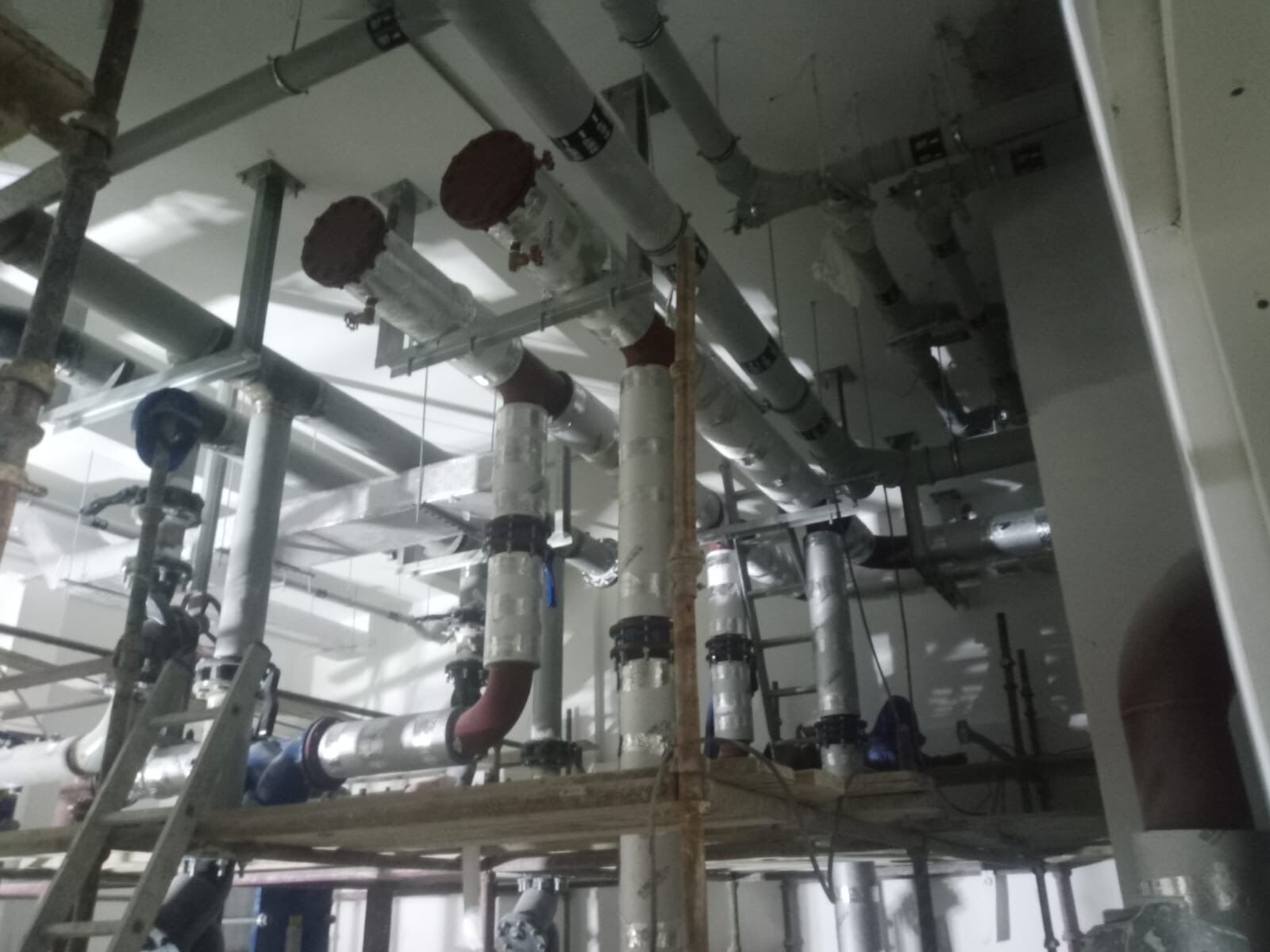 CHW pump room with insulated piping and valves