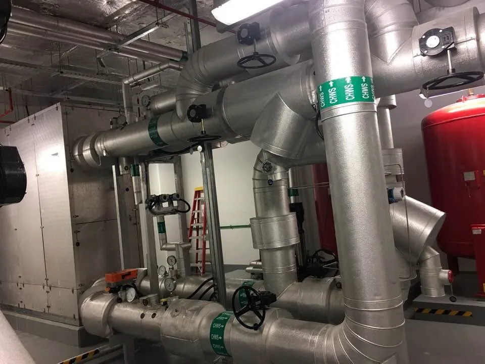 CHWS insulated pipework with valves and expansion vessel in a Dubai plant room